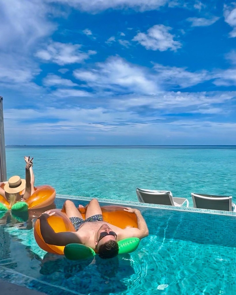 Pregnant woman in water villa pool Cora Cora Maldives babymoon"