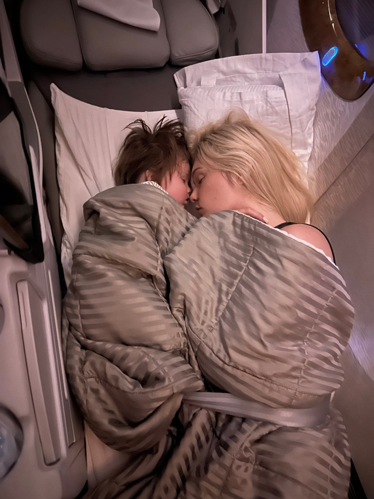 Women and baby asleep on an emirates flight in business class from South Africa to Dubai